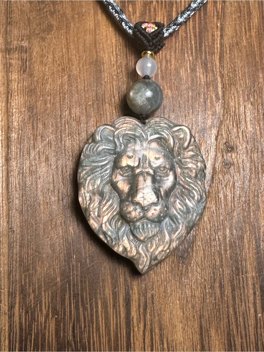 Pink Flash Labradorite Lion Head Carving Pendant on Blue Adjustable Rope
